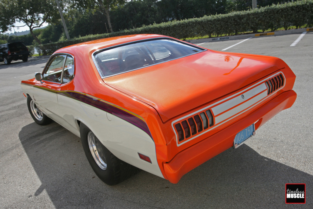The color combination of orange over white with the purple stripe that pays homage to the factory Demon belt line stripe is an outstanding choice for this car. Also, did you notice the absence of door handles and locks?