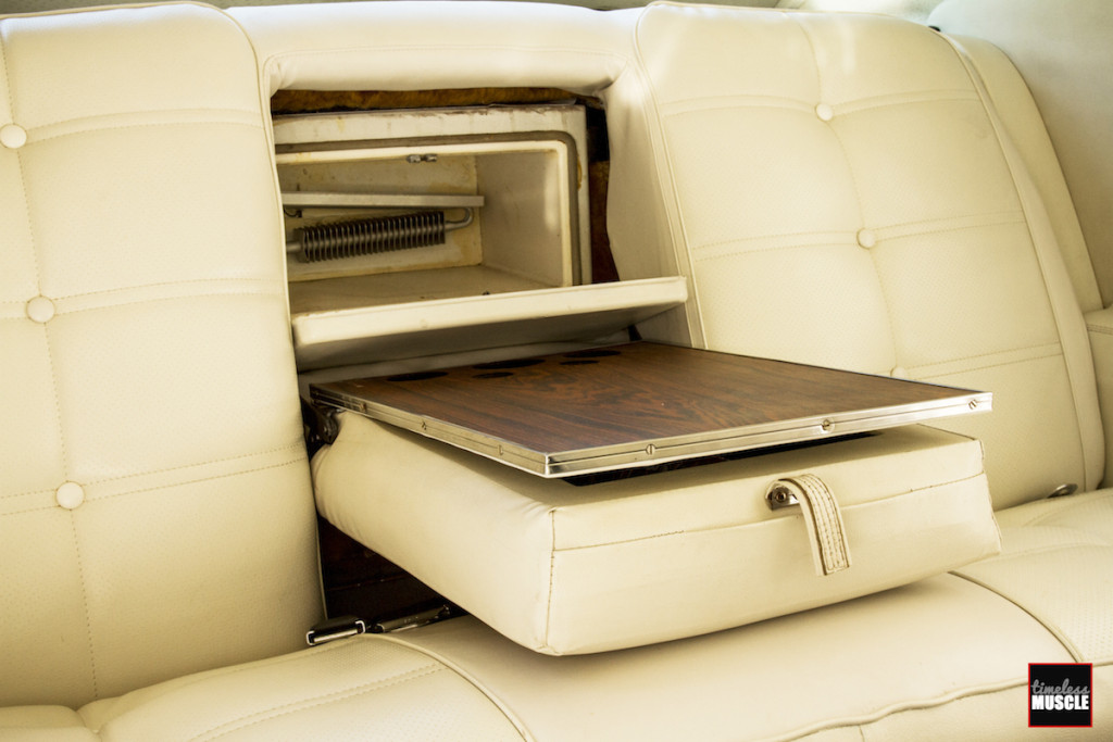 Cleverly hidden in the back seat was a wood-grain wet bar with bottle storage, and a 12V- or 120V-powered refrigerator. It would surely make long trips much nicer, and frankly, these options still aren’t that available in today’s cars